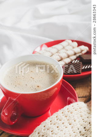 Cappuccino and Chocolate on a Bed with Plaid. Cappuccino and Chocolate on a Bed with Plaid. 28663343