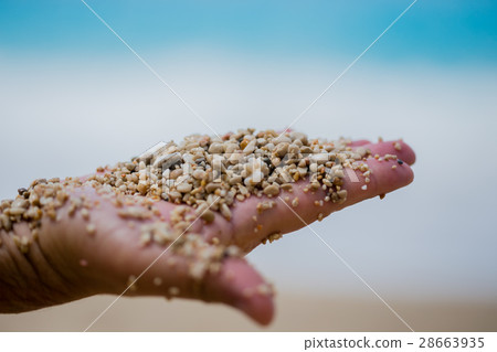 man palm holding pebble and sand man palm holding pebble and sand 28663935