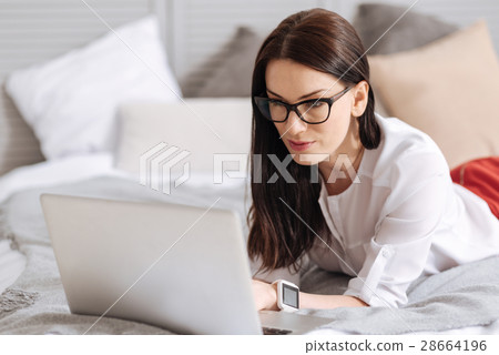 Pretty pleasant woman looking at the laptop screen 28664196