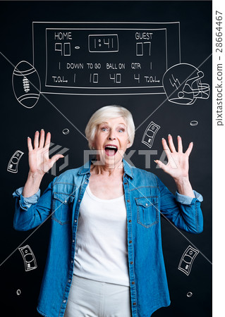 Joyful aged woman guessing the right score 28664467