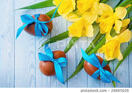 Easter eggs and fresh spring daffodils on Easter eggs and fresh spring daffodils on 28665026