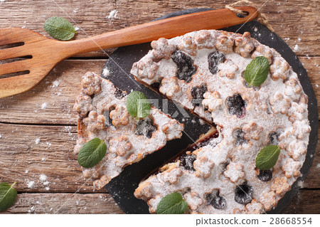 Sliced cake with plum jam and powdered sugar 28668554