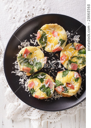 frittata with spinach, ham and cheese on a plate 28668568