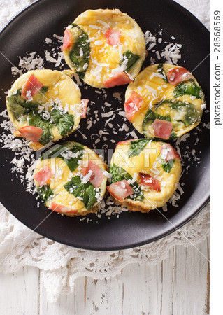 Omelet with spinach, ham and cheese on a plate 28668569