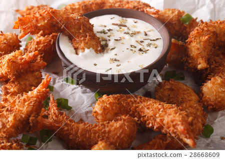 prawns fried in coconut close-up and cream sauce 28668609