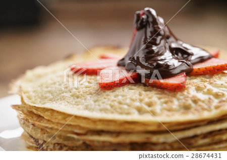 premium dark chocolate poured on blinis with 28674431