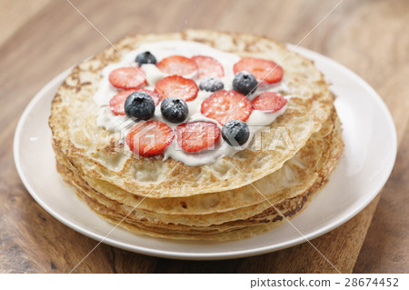fresh blinis or crepes with fresh berries and 28674452