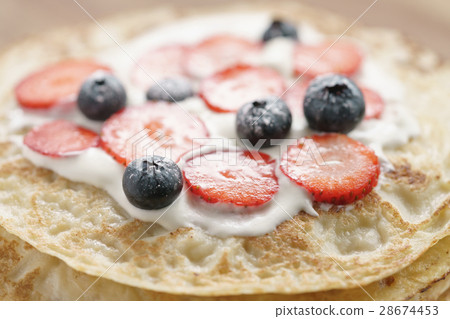 fresh blinis or crepes with fresh berries and 28674453