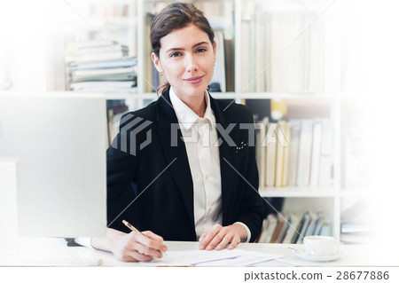 Smiling businesswoman at office Smiling businesswoman at office 28677886
