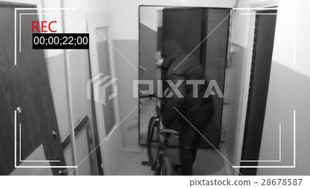 the young man in mask breaks the door and  28678587