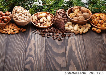 Various nuts on wooden table Various nuts on wooden table 28683318