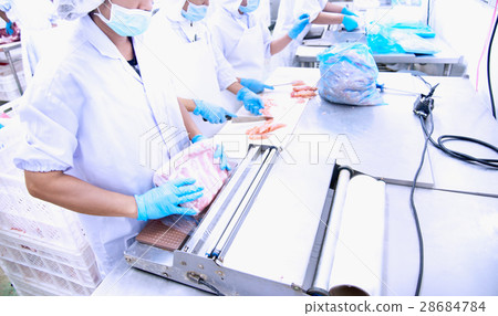 Butcher wrapping meat 28684784