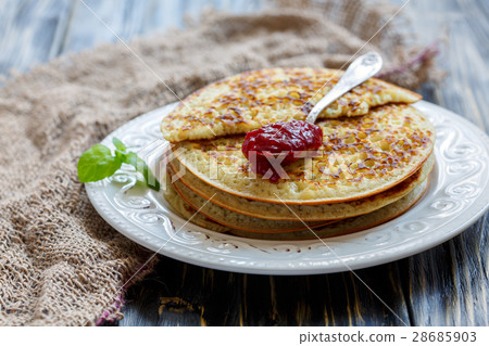Stack of pancakes and teaspoon with berry jam. 28685903