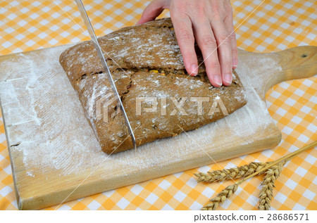 Cutting Dark Bread 28686571