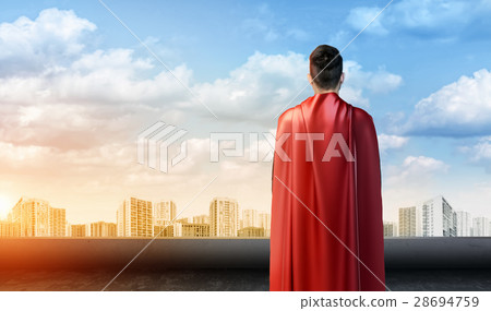 A businessman in superman cape standing turned 28694759