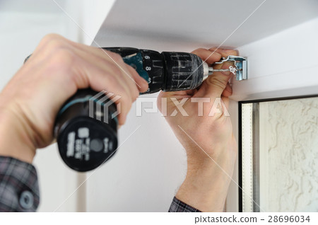 Installing wooden blinds. Installing wooden blinds. 28696034