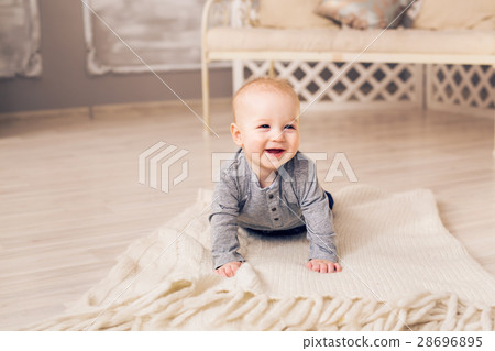 Laughing Baby Boy Lying On Tummy At Home Laughing Baby Boy Lying On Tummy At Home 28696895