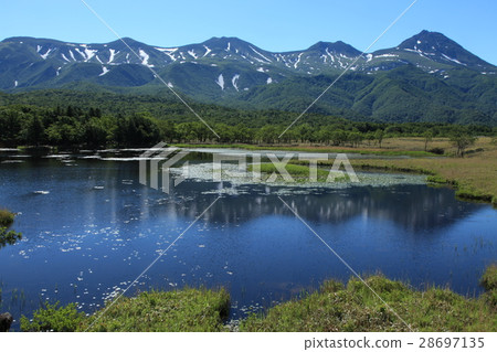 Shiretoko Ichinoseki where the surface of the water shines against the background of the Shiretoko mountain range of the remaining snow Shiretoko Ichinoseki where the surface of the water shines against the background of the Shiretoko mountain range of the remaining snow 28697135