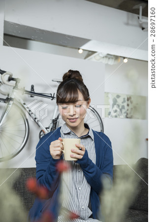 A woman enjoying tea time at home 28697160