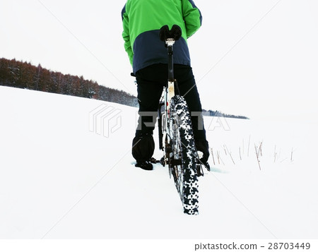 Man with mountain bike stay in powder snow. Man with mountain bike stay in powder snow. 28703449