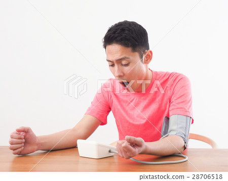 A surprising young man measuring blood pressure A surprising young man measuring blood pressure 28706518