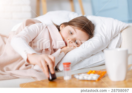 Sick little girl taking pills Sick little girl taking pills 28708097