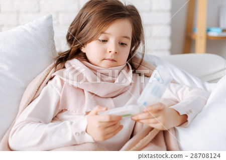 Cheerless little girl holding pills Cheerless little girl holding pills 28708124