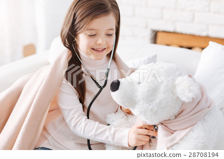Cheerful little girl playing with her fluffy toy Cheerful little girl playing with her fluffy toy 28708194
