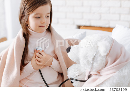 Pleasant little girl playing with fluffy bear Pleasant little girl playing with fluffy bear 28708199