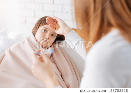 Caring mother measuring temperature of her sick Caring mother measuring temperature of her sick 28708228