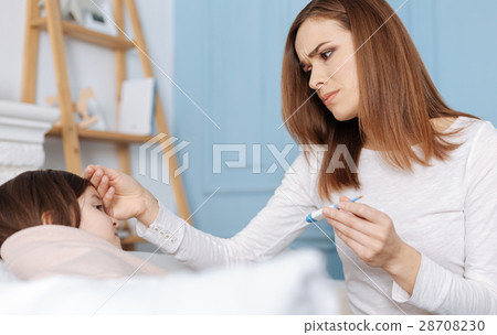 Loving concerned mother takign care of her Loving concerned mother takign care of her 28708230