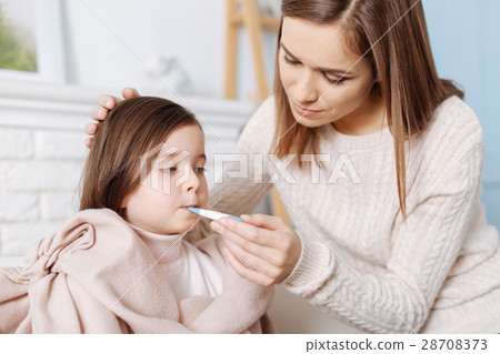 Pleasant loving mother measuring temperature of Pleasant loving mother measuring temperature of 28708373
