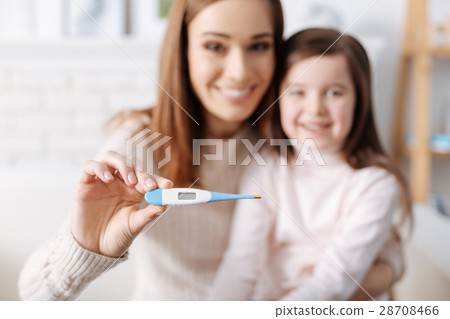 Joyful mother holding thermometer Joyful mother holding thermometer 28708466