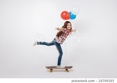Optimistic little child skateboarding in the Optimistic little child skateboarding in the 28709165