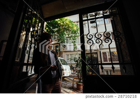 girl standing in the doorway to the street 28710218