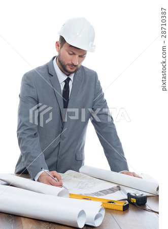 Handsome mature contractor drawing a building plan Handsome mature contractor drawing a building plan 28710387