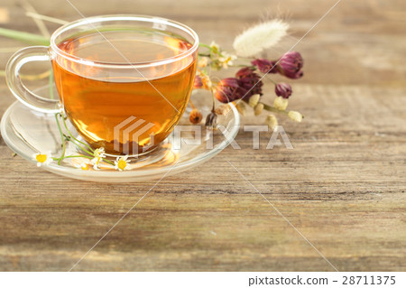 Tea and flowers on wooden background 28711375