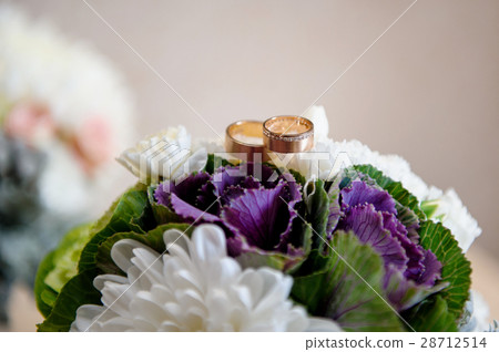 two golden rings on a wedding bouquet two golden rings on a wedding bouquet 28712514