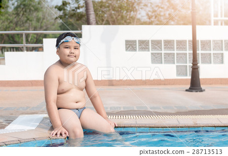 Obese fat boy sit on swimming pool 28713513