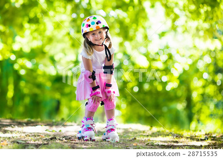 Little girl with roller skate shoes in a park Little girl with roller skate shoes in a park 28715535