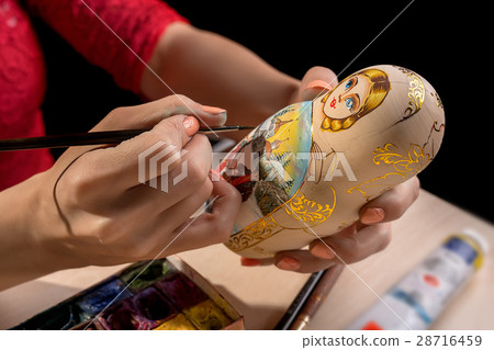 Master decorating matrioshka close up shot Master decorating matrioshka close up shot 28716459