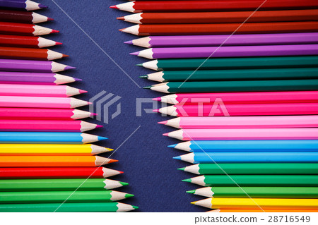 colored pencils on blue background lying in 28716549