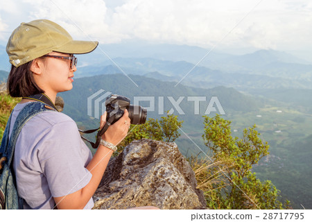 Hiker teen girl holding a camera for photography 28717795