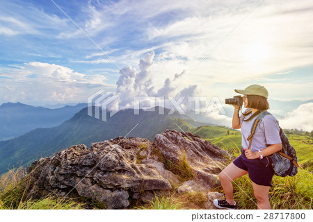Hiker teen girl holding a camera for photography 28717800