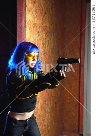 Beautiful girl with blue hair holding gun in strikeball location background 28718063