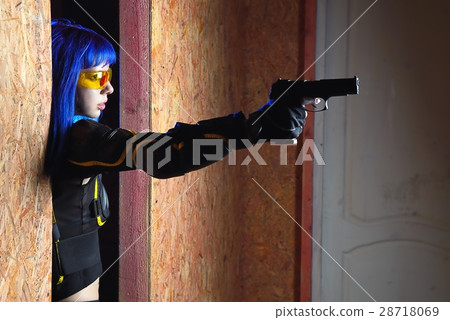 Beautiful girl with blue hair holding gun in strikeball location background 28718069