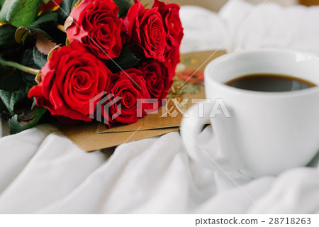cup of coffee and a bouquet of red roses, envelope cup of coffee and a bouquet of red roses, envelope 28718263