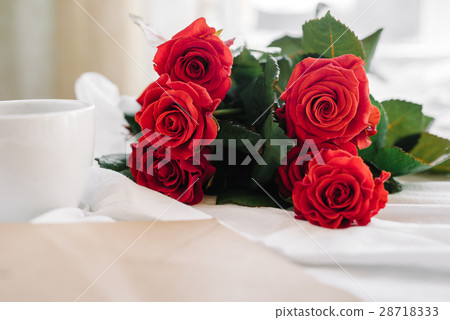 cup of coffee and a bouquet of red roses, envelope cup of coffee and a bouquet of red roses, envelope 28718333