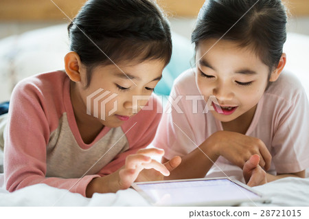 Young Children Studying On Bed 28721015
