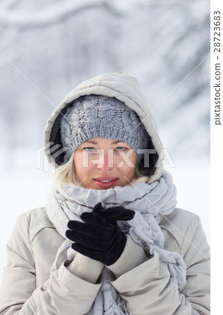 Portrait of lady outdoor in snow in cold winter 28723683